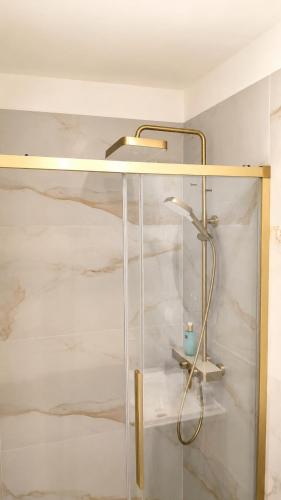 a glass shower cabinet with a shower head on top at Social Lodge Happiness Studios in Funchal