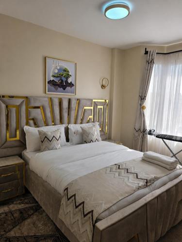 a bedroom with a large bed and a window at Savanna Living in Nakuru