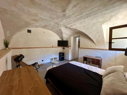 a bedroom with a bed and a table in a room at Studio le Replat in Aime-La Plagne