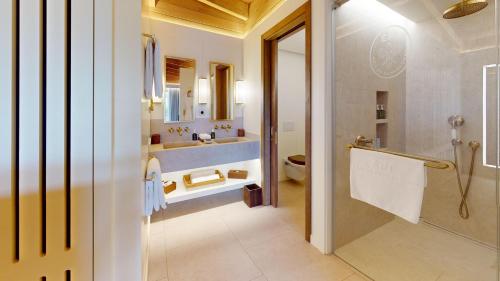 a bathroom with a sink and a shower and a toilet at Epi Baie de Pampelonne in Saint-Tropez