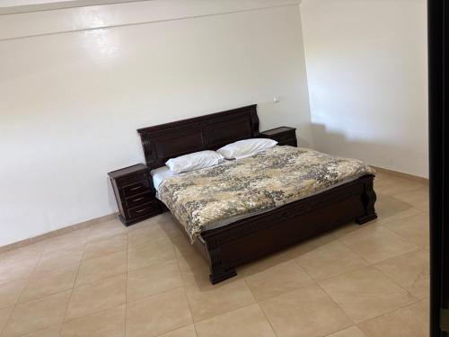 a bed with two pillows on it in a room at Magnifique Appartement à Louer C14 Jnane Dalya in Bouznika