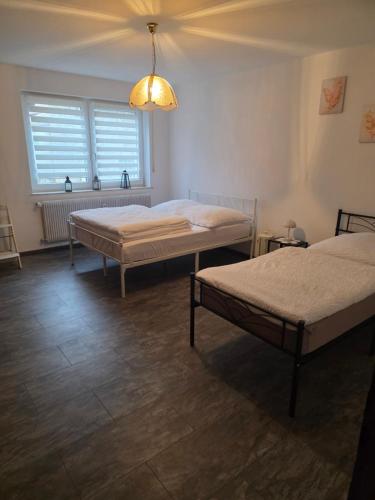a room with two beds and a window at Haus Raab in Knetzgau