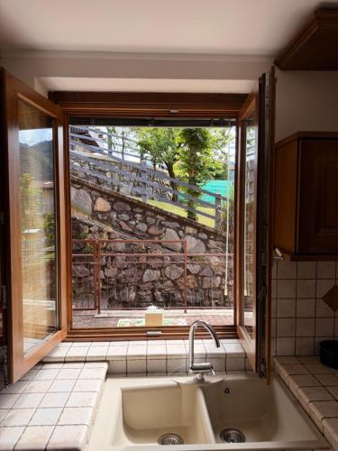 a kitchen with a sink and a large window at Pieve Antica in Piazza