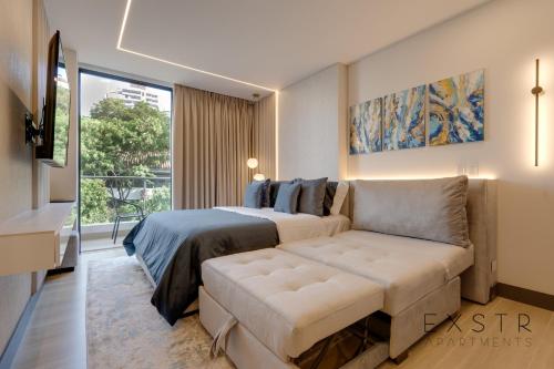 a bedroom with a bed and a couch and a window at Riomaggiore City Tower in Cali