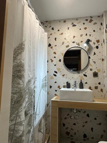 a bathroom with a sink and a mirror at My Afytos Balcony in Afitos