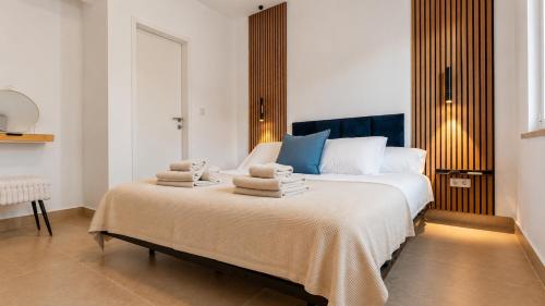 a bedroom with a large bed with towels on it at Zalazak in Bobovišća