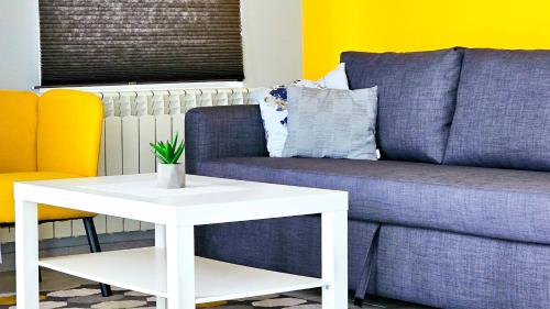 a living room with a couch and a white table at Apartmani Tika in Golubac
