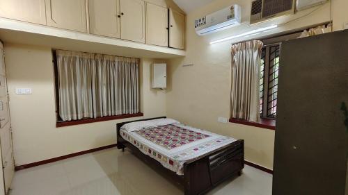 a bedroom with a small bed in a room at Kalliyattu Homestay in Palakkad