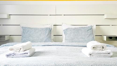 a white bed with towels on top of it at Apartmani Tika in Golubac