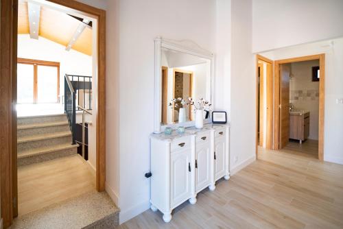 a hallway with a white dresser and a mirror at Casa ATARAXIA in Boiro