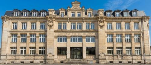 a large stone building with a tower on top at ARBELLIA Appart'Hôtel Châlons en Champagne in Chalons en Champagne