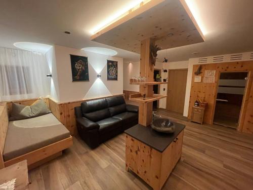 a living room with a couch and a table at Dorfblick Appartements & Rooms in Senales