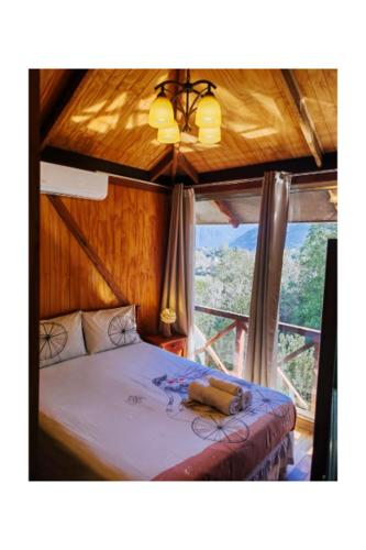 a bedroom with a bed in a room with a window at Hostal Chikiyan in San José de Maipo