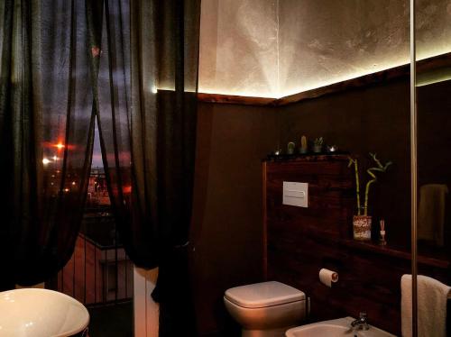 a bathroom with a toilet and a sink at La Suite Pisa in Pisa