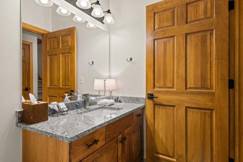 a bathroom with a sink and a mirror at 823 Mountain Cabin in Boyne Falls