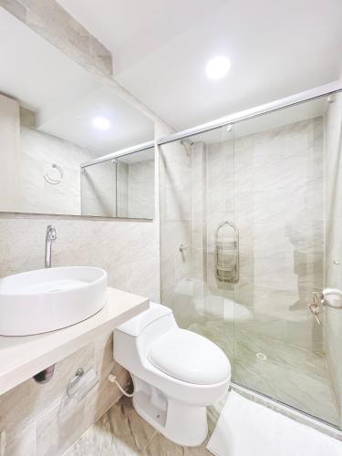 a bathroom with a toilet and a sink and a shower at Mirador, Coveñas 302 in Coveñas