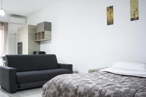 a bedroom with a bed and a chair at Suite in Città residence in Isernia