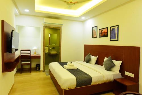 a bedroom with a large bed and a bathroom at The Marwar regency Hotel in Jodhpur