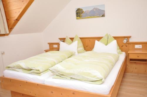 a bedroom with two beds with pillows at Ferienhof Berger in Rossleithen