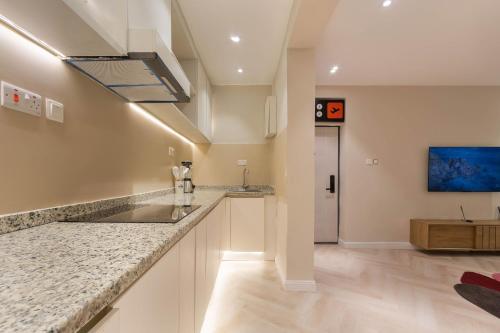 a kitchen with a sink and a counter top at The District Lekki by GCI in Lekki Phase 1