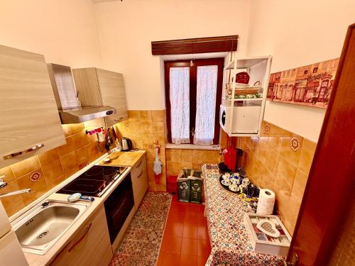 a small kitchen with a sink and a stove at Villa Nina Amalfi in Amalfi