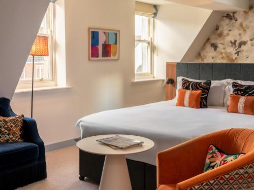 a hotel room with a bed and a table and chairs at Dylan in Dublin