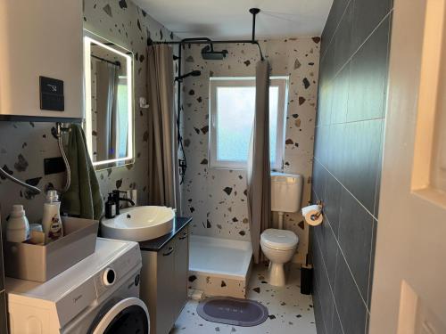 a bathroom with a sink and a toilet and a window at House Sweet stay by Deda Ferda late self check in in Draganići