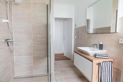 a bathroom with a sink and a shower at Modern Stay in Lemgo
