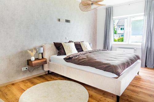 a bedroom with a large bed and a window at Modern Stay in Lemgo