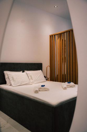 a bedroom with a bed with two towels on it at fenias luxury studios in Kallithea Halkidikis