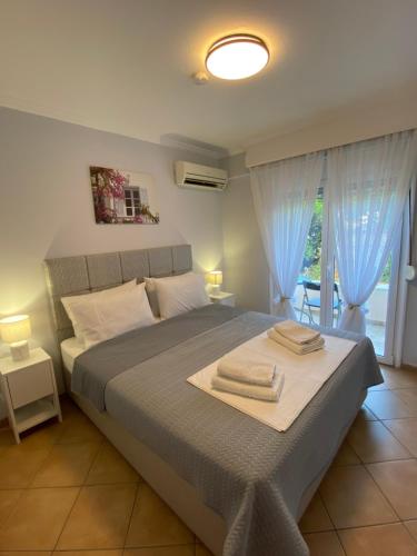 a bedroom with a bed with two towels on it at MarSia Apartment in Chios