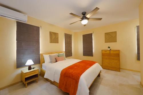 a bedroom with a bed and a ceiling fan at Santa Cruz Suites in Lower South Hill