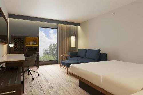 a hotel room with a bed and a desk at Courtyard by Marriott Torreón in Torreón