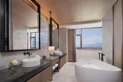 a bathroom with two sinks and a bath tub at Beijing Marriott Hotel Yanqing in Yanqing