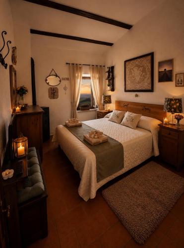 a bedroom with a large bed and a window at Casa Amiata 2 in Montelaterone