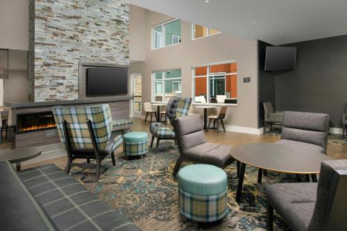 a living room with chairs and a fireplace at Residence Inn by Marriott Lexington in Lexington