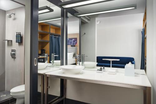 a bathroom with two sinks and a toilet at Aloft by Marriott Miami - Brickell in Miami