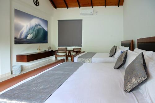 a bedroom with two beds and a large screen at Staysia Guest in Kandy