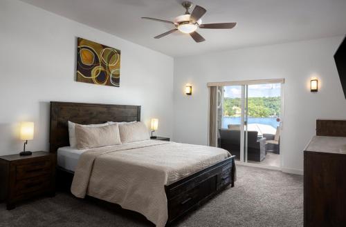 a bedroom with a bed and a ceiling fan at Coconuts RV Resort in Gravois Mills