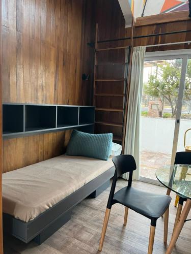 a bed in a room with a table and a chair at Abismo Privado Cabaña de Lujo con Jacuzzi in San Rafael