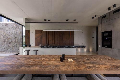 a kitchen with a large wooden table in a room at Predmet Kabakaba Resort in Tumbak Bayuh