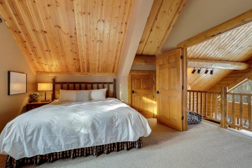 a bedroom with a bed and a wooden ceiling at 823 Mountain Cabin in Boyne Falls