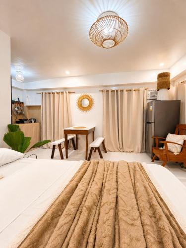 a large bedroom with a large bed and a table at A&H Homestay in Catangnan