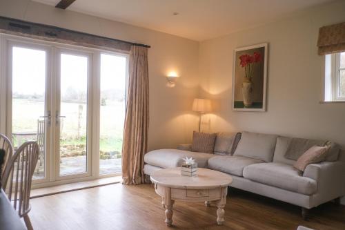 a living room with a couch and a table at Highfield in Petworth