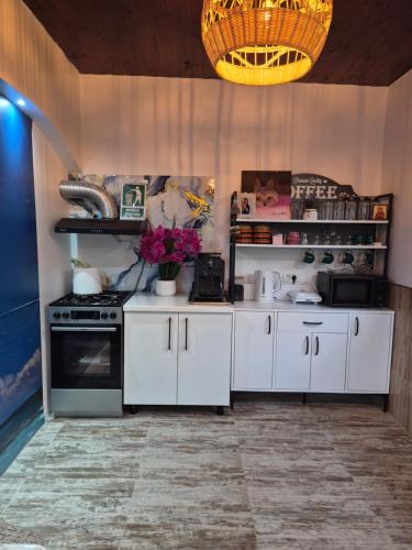 a kitchen with white cabinets and a stove at Kallithea in 2 Mai