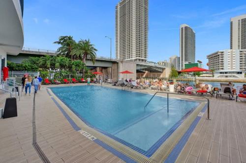 a swimming pool in the middle of a city at Charming Studio by the Ocean Beach Service in Hallandale Beach