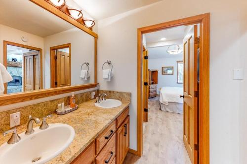 a bathroom with two sinks and a large mirror at Summit 70 in Mammoth Lakes
