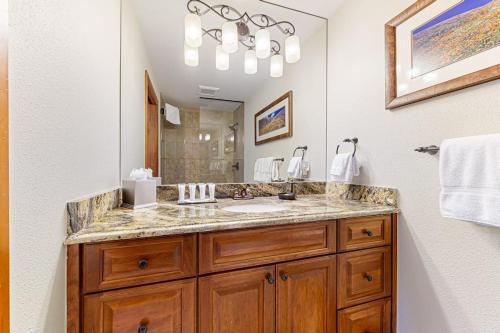 a bathroom with a sink and a large mirror at Lion Square Lodge South 451 in Vail