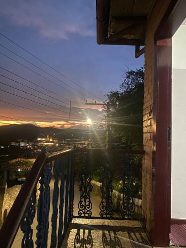 a view from the balcony of a house at sunset at Kitnet Imperial in Ouro Preto