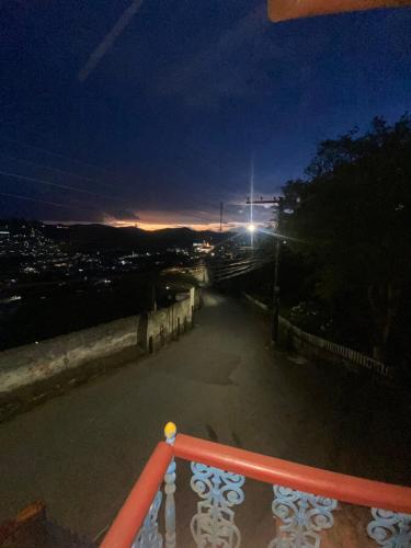 a view of a street at night with a light at Kitnet Imperial in Ouro Preto